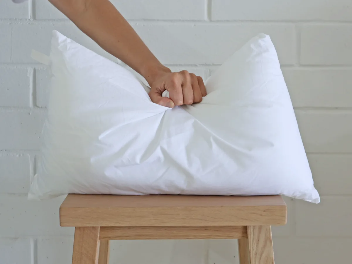 An insert is being pushed by an arm.