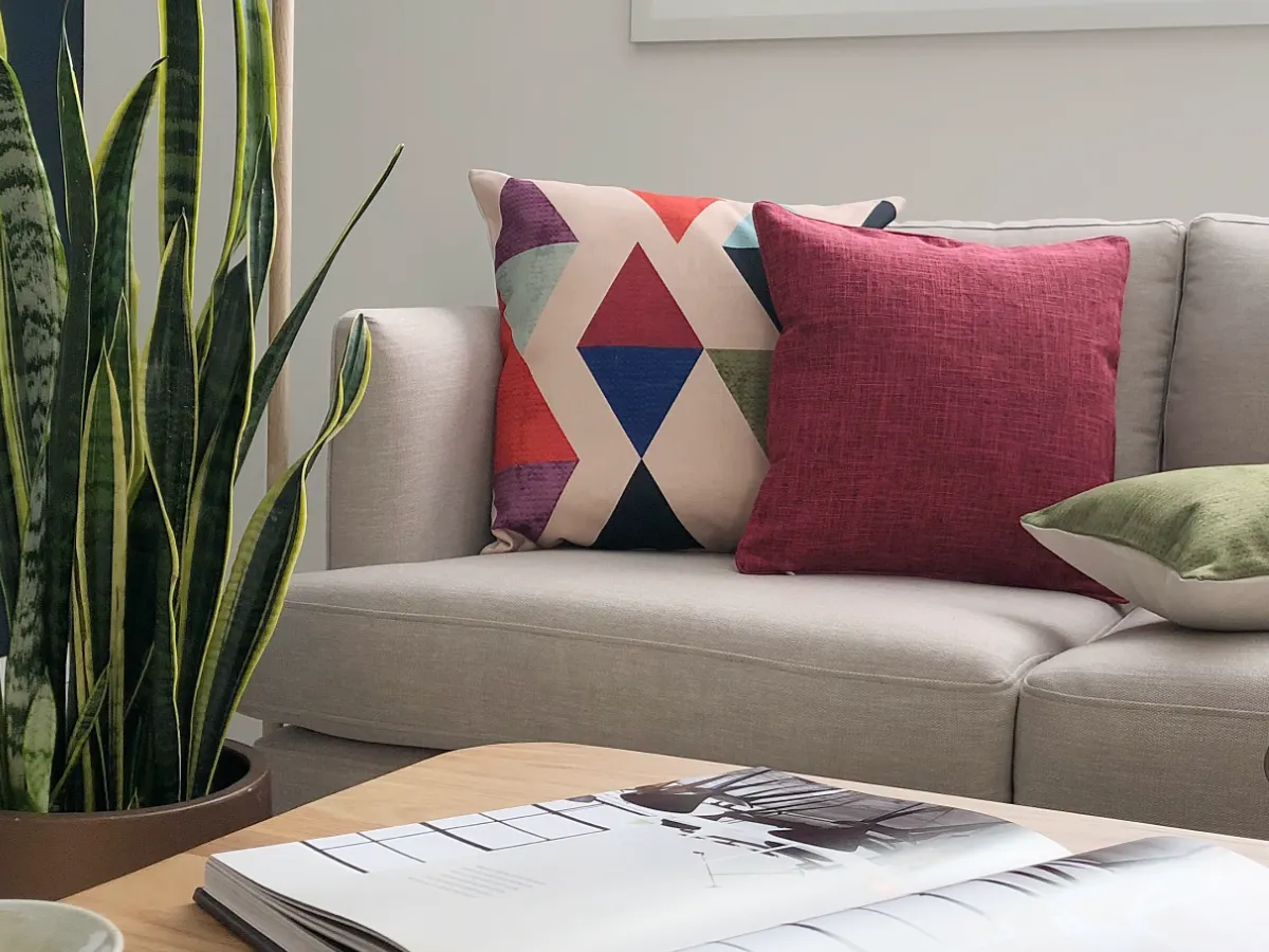 A simple sofa with a series of coloured cushions that are coordinated.