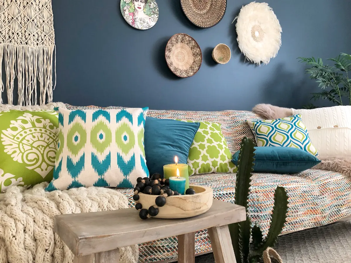 A boho chic inspired room with bohemian cushions decorating a sofa.