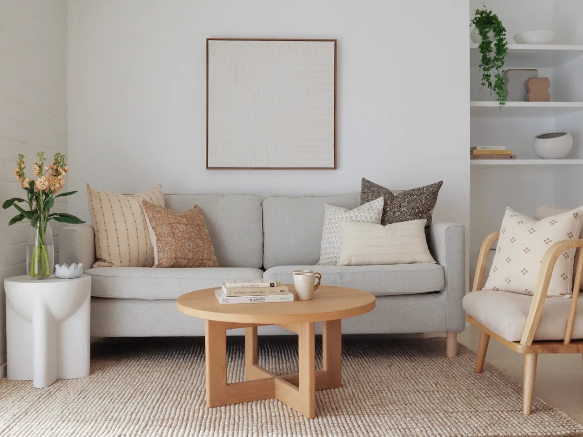 A number of cushions on a sofa that have been styled in clusters and pairs.