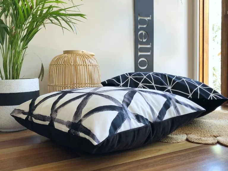 Black and white large floor pillows on a wooden floor