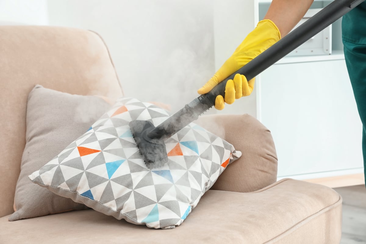 A team cleaner being used to clean cushions.