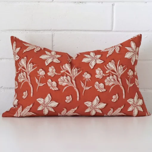 A premium linen rust cushion boasting a floral design and in a rectangle size.