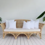 A set of 5 faux feather outdoor cushion inserts positioned on a sofa.
