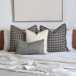 The Darcy bed cushions set is neatly arranged on a wooden bed.