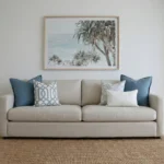 Eva cushions arranged on sofa with blue, white and geometric patterned cushions.