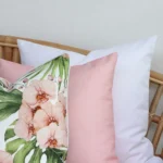 A magnified view of this set of three pink outdoor cushion covers corner shows greater detail.