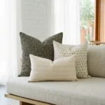 Hali cushions on sofa with black dotted pattern and small beige motif cushions.