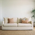 Hunter cushions styled on sofa with neutral, rust and patterned cushions.