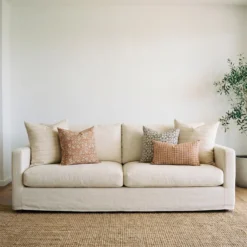 Hunter cushions styled on sofa with neutral, rust and patterned cushions.