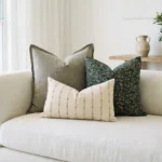 Jude cushions on sofa with gingham, striped and dark green floral designs.