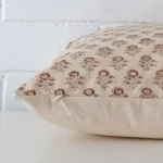 Square designer cushion cover positioned flat to show seams. It has a beautiful floral design.