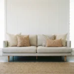 Lennox cushions arranged on sofa with beige, floral and check patterned cushions.