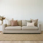 Luka cushions styled on beige sofa with rust, green and striped patterns.