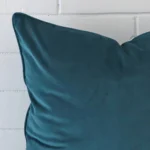 Close up image of velvet large cushion. The image allows you to see the teal hue more thoroughly.