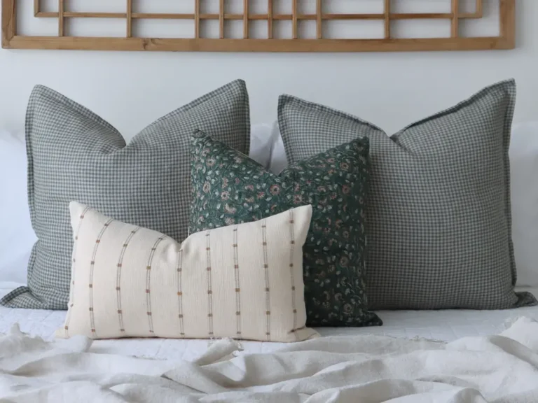 Four different cushion sizes arranged on a bed.