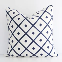 A premium outdoor navy beige cushion boasting a geometric design and in a square size.