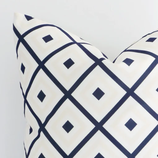 Cropped shot of top left corner of this outdoor navy beige cushion cover. This viewpoint shows the outdoor fabric and square shape with more precision.