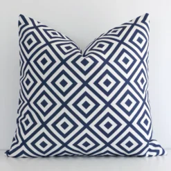 A premium outdoor navy cushion boasting a geometric design and in a square size.