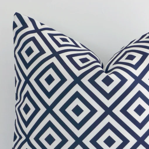 Very close photo of navy geometric cushion. The shot shows the outdoor material and square dimensions with more clarity.