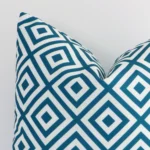 Precision shot of this square teal cushion cover. It is possible to see the geometric style and outdoor fabric in greater depth.