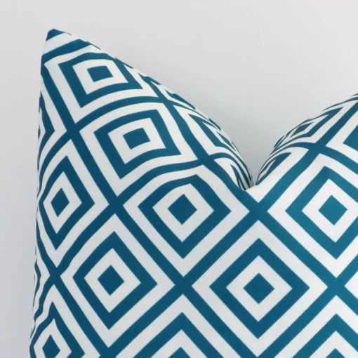 Precision shot of this square teal cushion cover. It is possible to see the geometric style and outdoor fabric in greater depth.