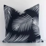 An eye-catching outdoor square cushion cover featuring a hue that is black and white. It has a unique palm design.