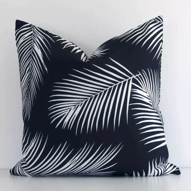 An eye-catching outdoor square cushion cover featuring a hue that is black and white. It has a unique palm design.