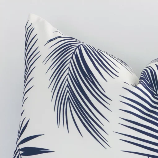 A detailed shot of this navy palm-styled cushion cover that has outdoor fabric and a rectangle shape.