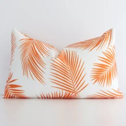 Vibrant orange palm-styled cushion cover constructed from outdoor fabric and shown in a rectangle shape.