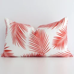 A graceful rectangular red cushion with a palm style on durable outdoor fabric.