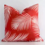 An alluring outdoor square cushion cover in red colour. It features an attractive palm style.
