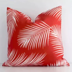 An alluring outdoor square cushion cover in red colour. It features an attractive palm style.