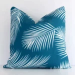 A stunning square outdoor cushion in a teal colour. It has an exquisite design.