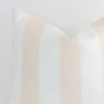 Extreme close up of a large beige cushion. The palm style and outdoor fabric are shown with a much higher degree of detail.