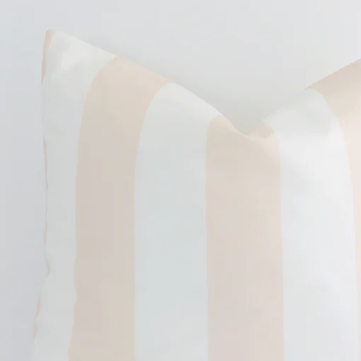Extreme close up of a large beige cushion. The palm style and outdoor fabric are shown with a much higher degree of detail.