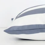 Side shot showing the seam of this large grey cushion that features a striped motif on its outdoor material.