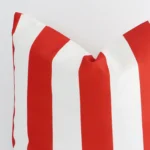 Zoomed in visual of outdoor large cushion cover in white and red. The intricacies of its striped design are visible.