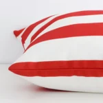 A magnified shot of a red striped outdoor cushion cover in a large size.