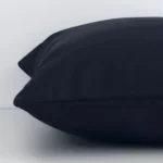 Black solid-coloured cushion cover laid on its back side. The image shows a side-on view of the outdoor material and its square dimensions.