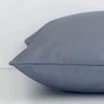 Square grey cushion laid flat. This view shows the solid-coloured style and outdoor fabric from side on.