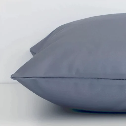 Square grey cushion laid flat. This view shows the solid-coloured style and outdoor fabric from side on.