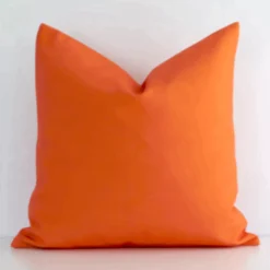 Vibrant solid-coloured outdoor cushion cover in a stylish square size with orange colouring.