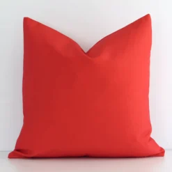 A premium outdoor red cushion boasting a solid-coloured design and in a square shape.