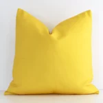 An eye-catching outdoor square cushion cover featuring a hue that is yellow. It has a solid-coloured style.