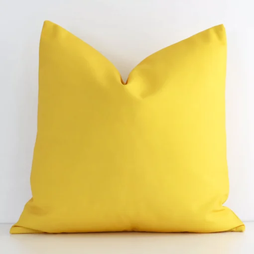 An eye-catching outdoor square cushion cover featuring a hue that is yellow. It has a solid-coloured style.