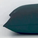 Lateral viewpoint of this outdoor square cushion. The solid-coloured design and dark green colour is shown from the side showing the front and rear panels.