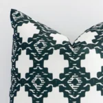 Magnified view of this linen green cushion cover’s corner showing a patterned design and its square size.