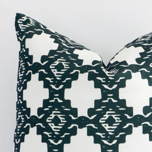 Magnified view of this linen green cushion cover’s corner showing a patterned design and its square size.