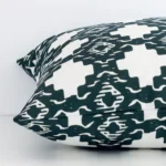 Lateral view of front and back panels of this patterned linen cushion cover in a square size. It has a green print.